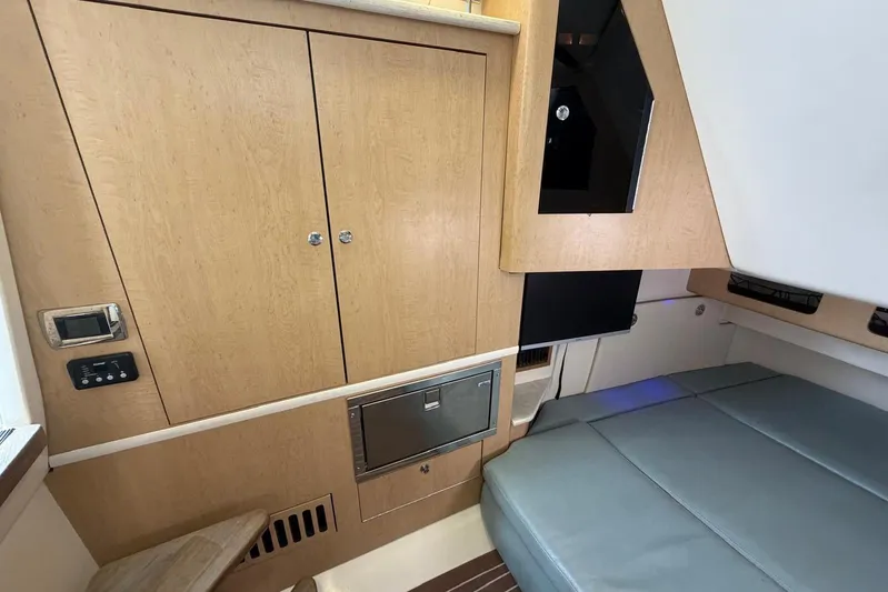  Yacht Photos Pics Interior of 2010 Boston Whaler 370 Outrage, featuring wood cabinetry and cushioned seating.