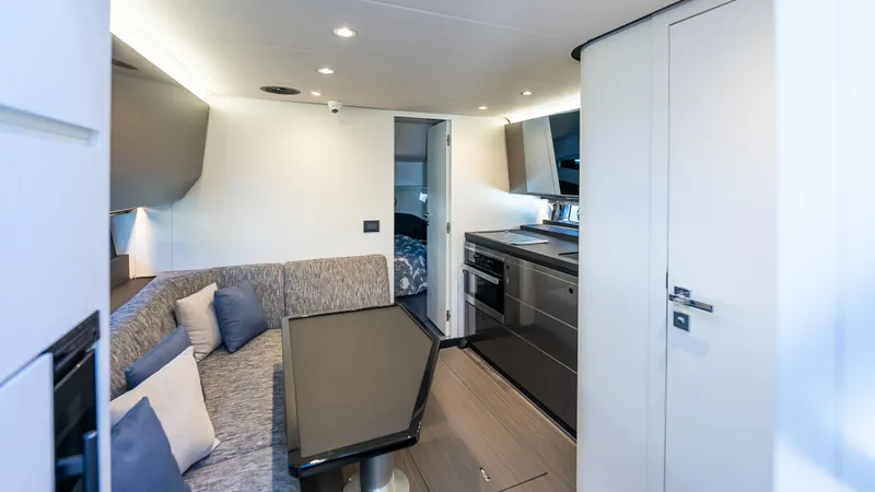 G-jazss Yacht Photos Pics Interior of 2022 Azimut Verve 47 yacht, featuring modern kitchen and cozy seating area.