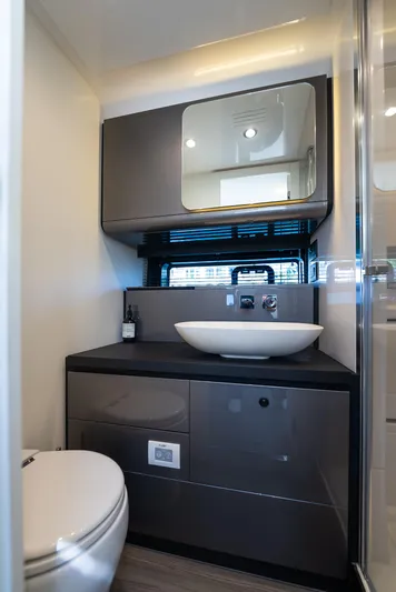 G-jazss Yacht Photos Pics Modern bathroom interior of 2022 Azimut Verve 47 yacht with sleek fixtures and mirror.