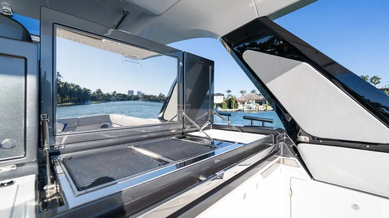 G-jazss Yacht Photos Pics 2022 Azimut Verve 47 yacht with open grill, scenic waterfront view.