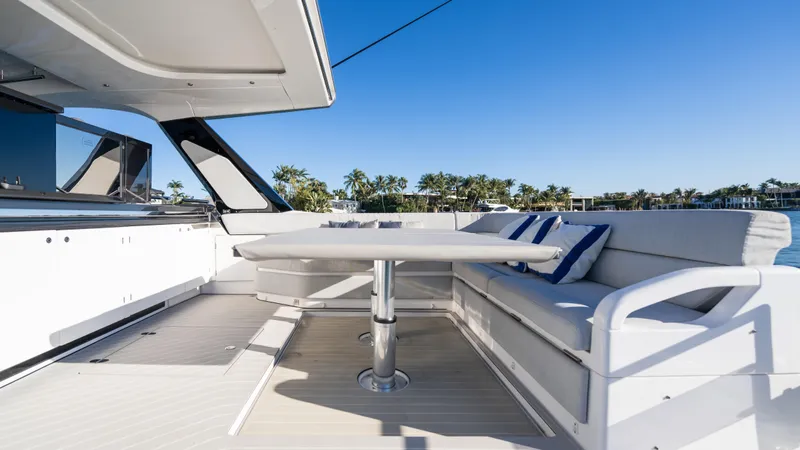 G-jazss Yacht Photos Pics 2022 Azimut Verve 47 yacht deck with seating and table, under clear blue sky.