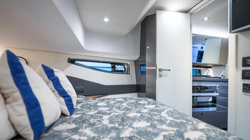 G-jazss Yacht Photos Pics Luxurious interior of 2022 Azimut Verve 47 yacht with modern bedroom and kitchen.