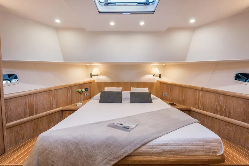 Sasga Yachts 68 Flybridge Yacht Photos Pics Luxurious cabin interior of 2026 Sasga Yachts Menorquin 68 FB with elegant bedding.