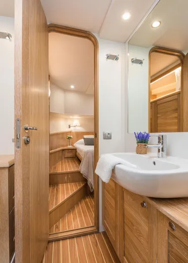 Sasga Yachts 68 Flybridge Yacht Photos Pics Luxurious bathroom interior of 2026 Sasga Yachts Menorquin 68 FB with wooden accents.