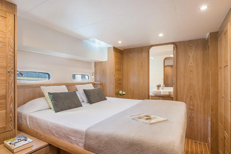 Sasga Yachts 68 Flybridge Yacht Photos Pics Luxurious cabin interior of 2026 Sasga Yachts Menorquin 68 FB with elegant wood finish.