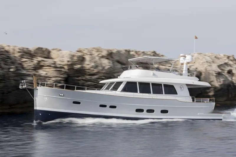 Sasga Yachts 68 Flybridge Yacht Photos Pics 2026 Sasga Yachts Menorquin 68 FB cruising near rocky coastline.