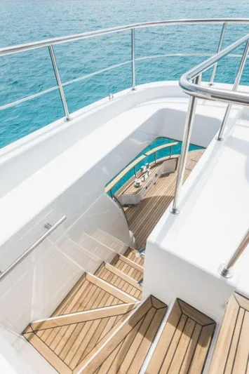 Sasga Yachts 68 Flybridge Yacht Photos Pics Staircase on 2026 Sasga Yachts Menorquin 68 FB, overlooking clear blue water.