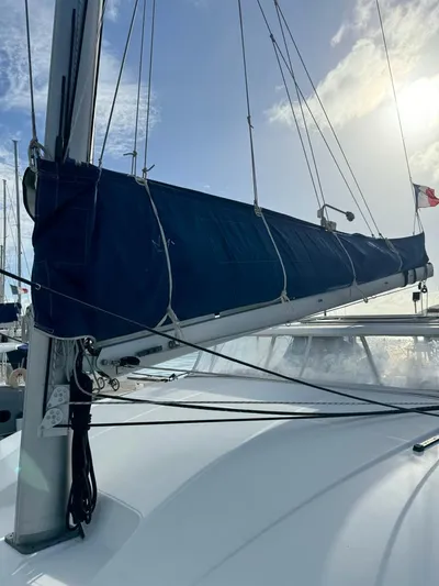 Oscar III Yacht Photos Pics 2018 Lagoon 380 sailboat with blue sail cover, docked under a clear sky.