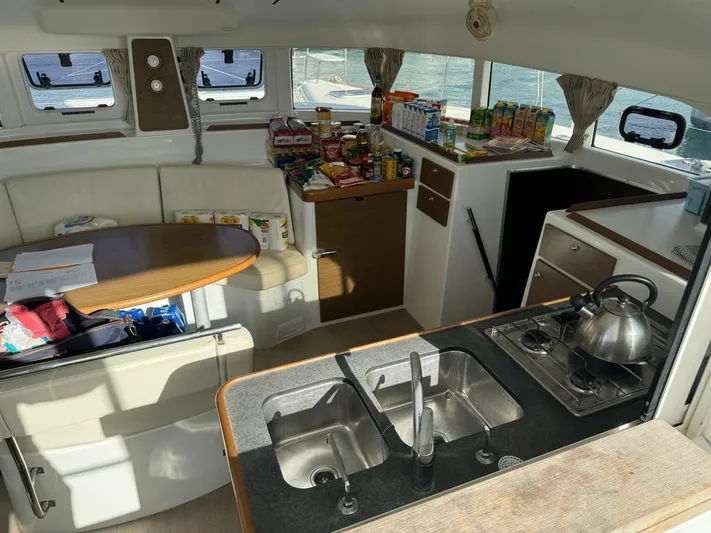 Oscar III Yacht Photos Pics Interior of 2018 Lagoon LAGOON 380 catamaran with kitchen, dining area, and stocked provisions.