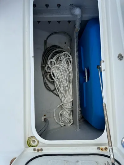 Oscar III Yacht Photos Pics Storage compartment on 2018 Lagoon 380 catamaran with ropes and blue container.