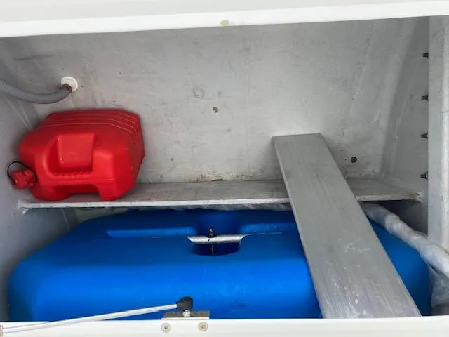Oscar III Yacht Photos Pics Storage compartment of 2018 Lagoon LAGOON 380 with red and blue containers.