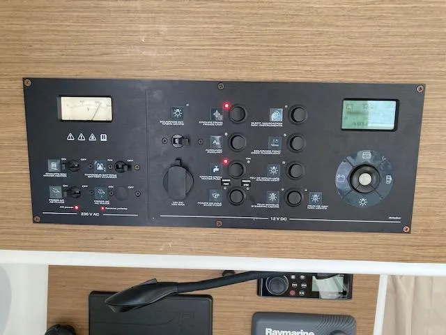 Oscar III Yacht Photos Pics Control panel of a 2018 Lagoon LAGOON 380 catamaran with various switches and displays.