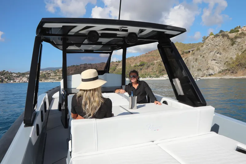  Yacht Photos Pics Two people relaxing on a 2026 Ranieri CAYMAN 45.0 Cruiser in scenic waters.