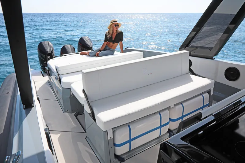 Yacht Photos Pics 2026 Ranieri CAYMAN 45.0 Cruiser with woman relaxing on deck, ocean backdrop.