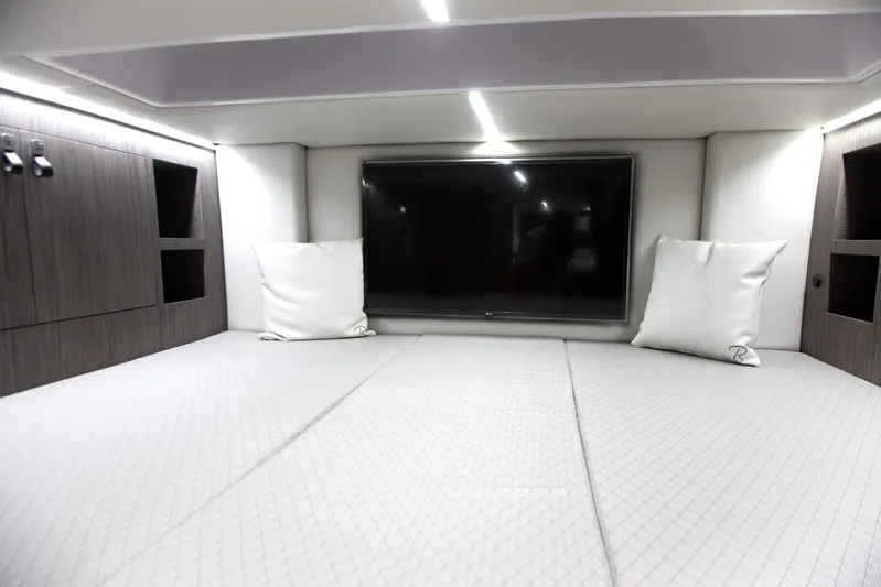  Yacht Photos Pics Luxurious interior cabin of 2026 Ranieri CAYMAN 45.0 Cruiser with modern TV setup.