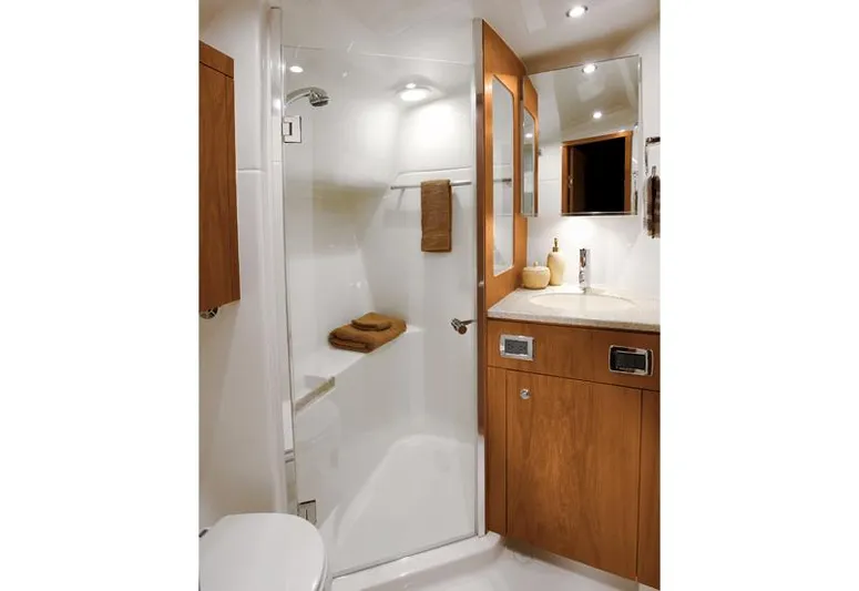 Fifth Case Yacht Photos Pics Manufacturer Provided Image: Luxurious bathroom in 2016 Tiara Yachts 4300 Open with glass shower and wooden cabinetry.