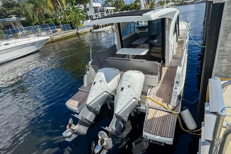  Yacht Photos Pics 2022 Beneteau Antares 11 docked, featuring dual outboard engines and spacious deck area.