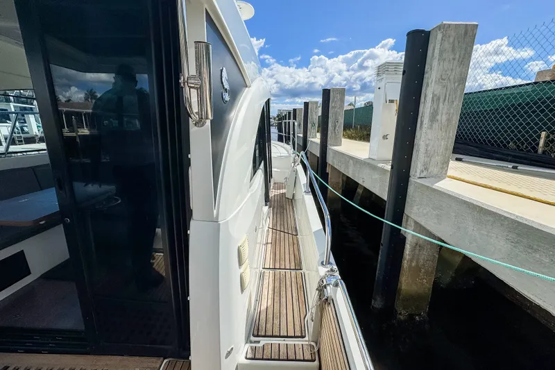  Yacht Photos Pics 2022 Beneteau Antares 11 docked, showcasing sleek design and wooden deck details.