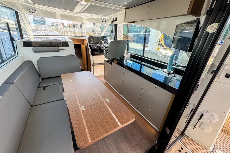  Yacht Photos Pics Interior of 2022 Beneteau Antares 11 yacht with modern seating and navigation area.