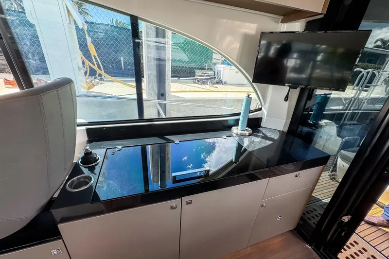  Yacht Photos Pics Interior of 2022 Beneteau Antares 11 yacht with sleek kitchen and mounted TV.