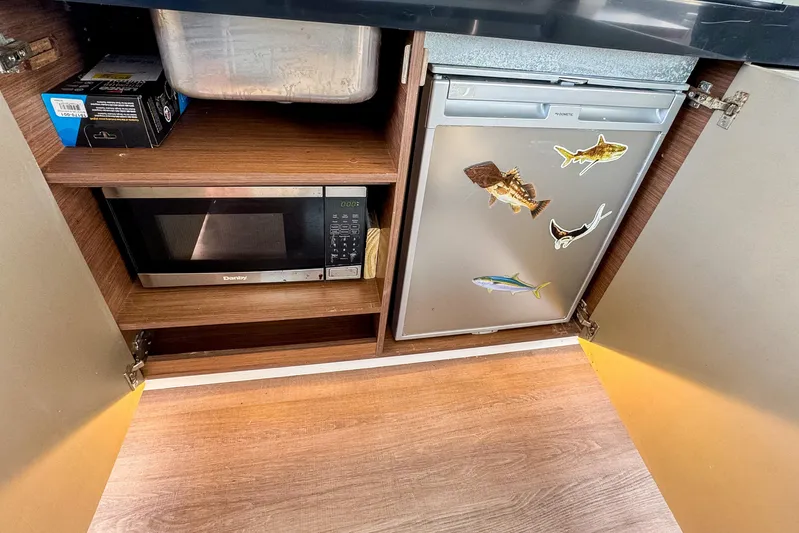  Yacht Photos Pics Kitchen area in 2022 Beneteau Antares 11 with microwave and mini fridge.