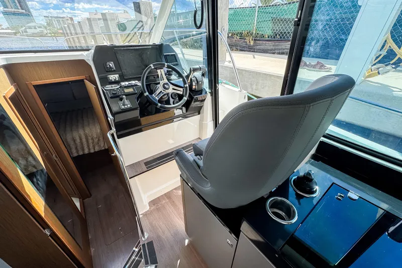 Yacht Photos Pics Interior view of 2022 Beneteau Antares 11 helm with modern controls and seating.