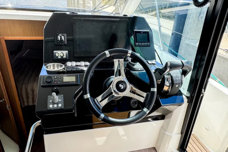  Yacht Photos Pics Helm of 2022 Beneteau Antares 11 with modern controls and steering wheel.