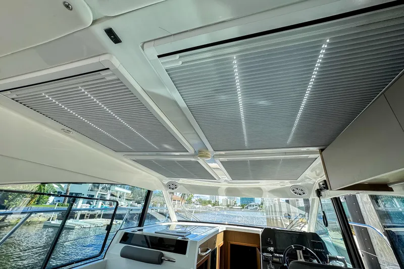  Yacht Photos Pics Interior view of 2022 Beneteau Antares 11 boat with modern ceiling design.