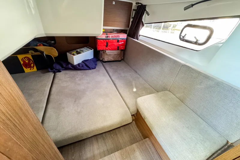  Yacht Photos Pics Interior of 2022 Beneteau Antares 11 with seating, window, and life jackets.