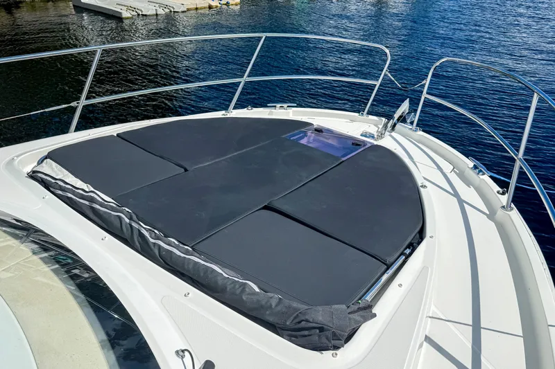  Yacht Photos Pics 2022 Beneteau Antares 11 boat with sunbathing deck on calm water.