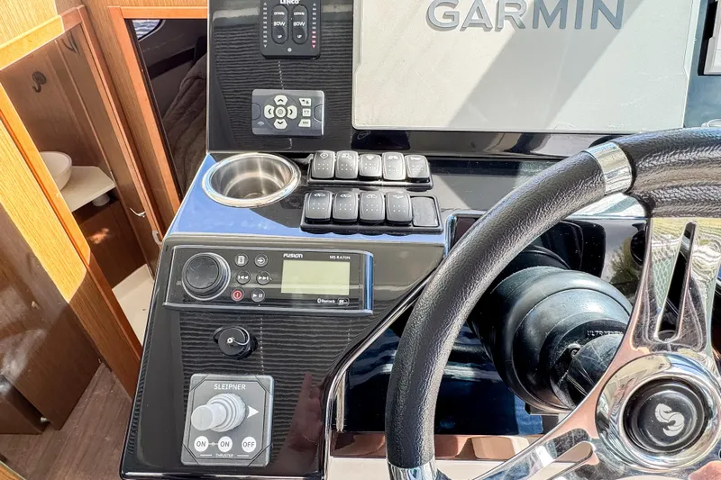  Yacht Photos Pics Control panel of 2022 Beneteau Antares 11 with Garmin navigation system and steering wheel.
