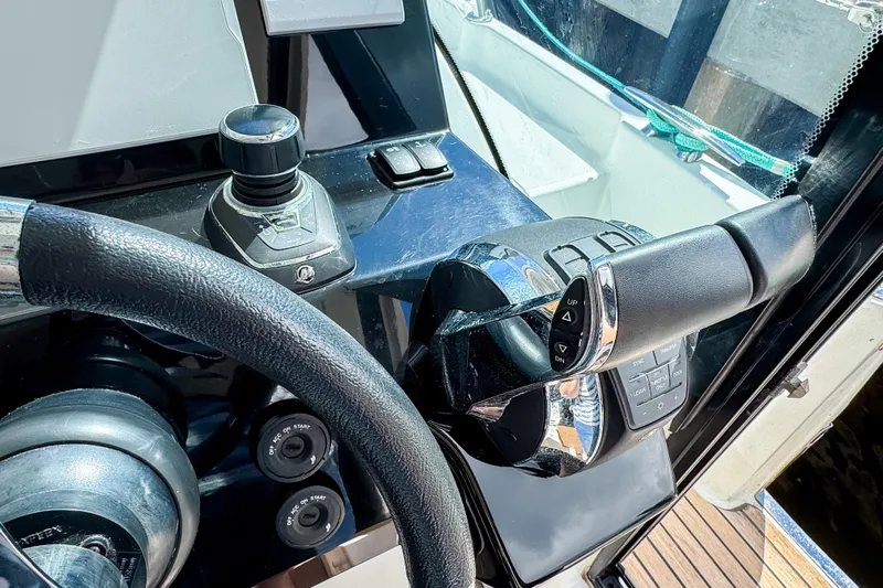  Yacht Photos Pics Control panel of 2022 Beneteau Antares 11 boat with steering wheel and throttle.