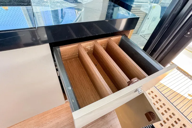  Yacht Photos Pics Open drawer with wooden dividers on 2022 Beneteau Antares 11 yacht.