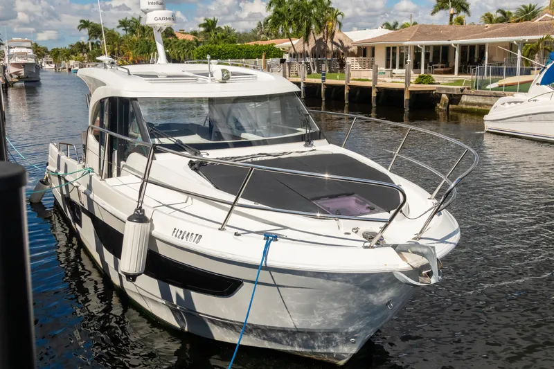  Yacht Photos Pics 2022 Beneteau Antares 11 docked in a sunny marina setting.
