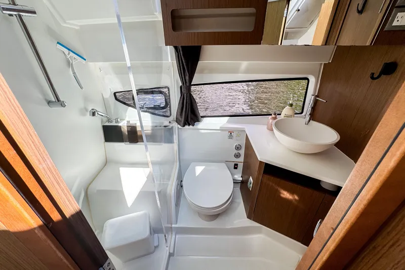  Yacht Photos Pics Modern bathroom interior of 2022 Beneteau Antares 11 yacht, featuring sleek design and amenities.