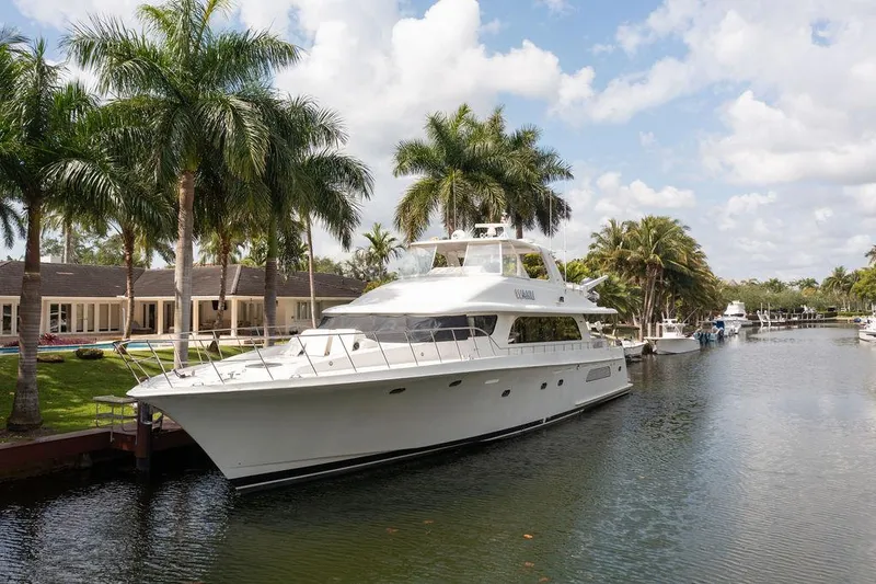 Yacht Photos Pics 2004 Cheoy Lee 84 Bravo Flybridge yacht docked by palm trees and waterfront homes.