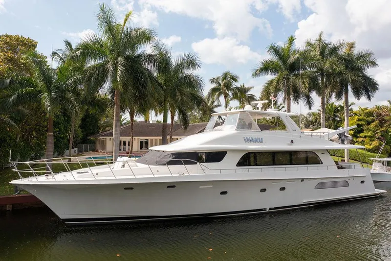  Yacht Photos Pics 2004 Cheoy Lee 84 Bravo Flybridge yacht docked near palm trees.