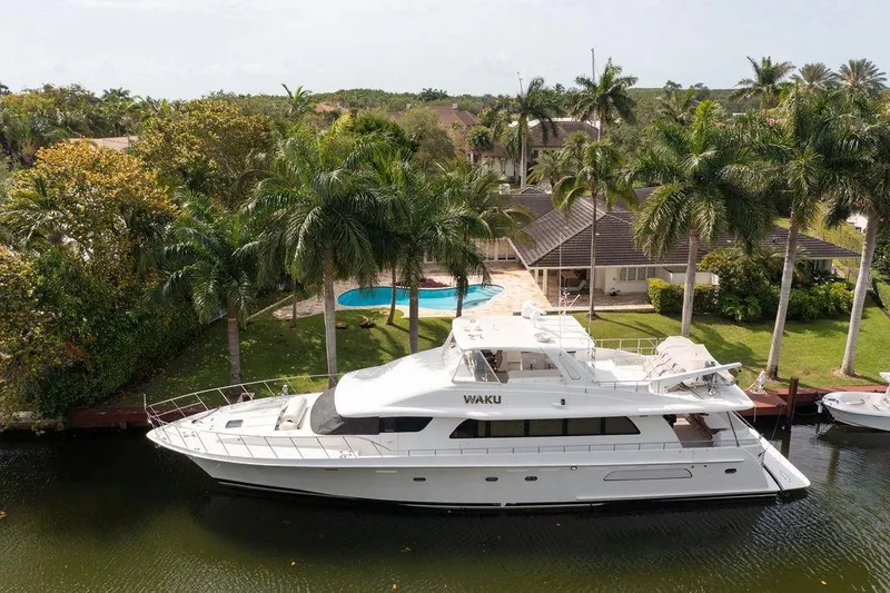  Yacht Photos Pics 2004 Cheoy Lee 84 Bravo Flybridge yacht docked by a tropical waterfront home.