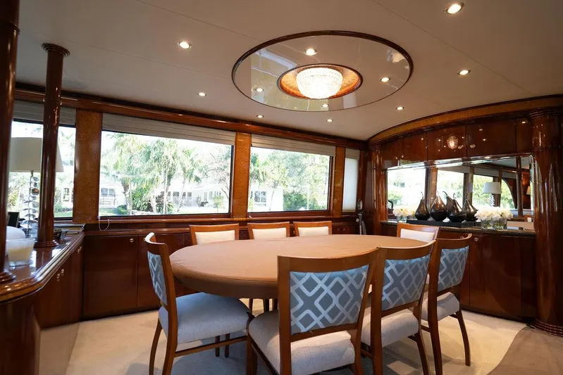  Yacht Photos Pics Luxurious dining area in 2004 Cheoy Lee 84 Bravo Flybridge yacht with elegant wood finishes.