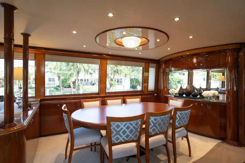  Yacht Photos Pics Luxurious dining area on 2004 Cheoy Lee 84 Bravo Flybridge yacht with elegant wood finishes.