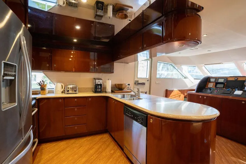  Yacht Photos Pics Luxurious kitchen interior of 2004 Cheoy Lee 84 Bravo Flybridge yacht with modern appliances.