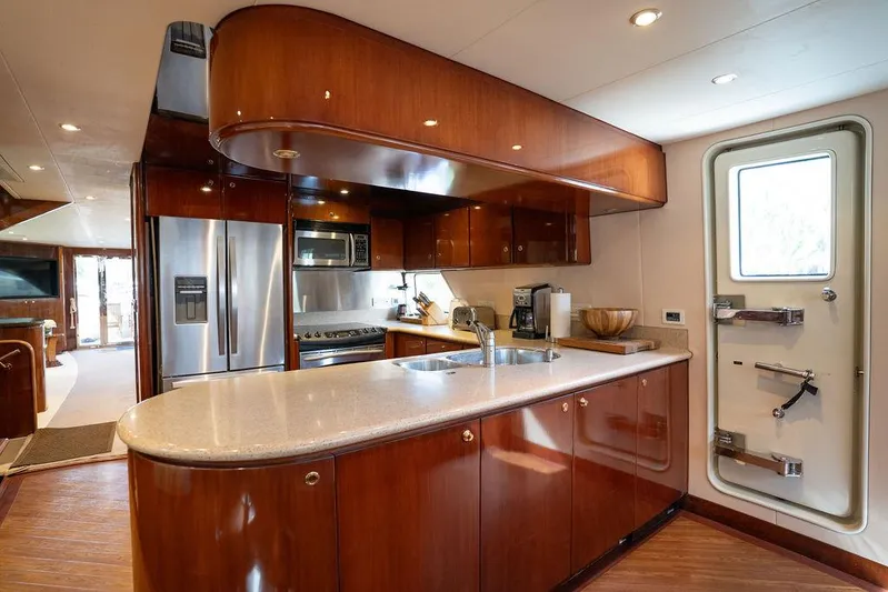  Yacht Photos Pics Luxurious kitchen interior of 2004 Cheoy Lee 84 Bravo Flybridge yacht with modern amenities.