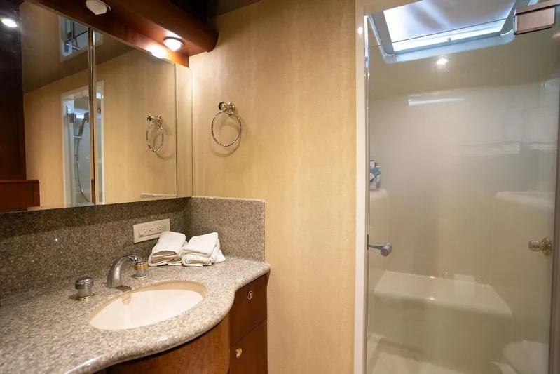  Yacht Photos Pics Luxurious bathroom in 2004 Cheoy Lee 84 Bravo Flybridge yacht with granite countertop and shower.