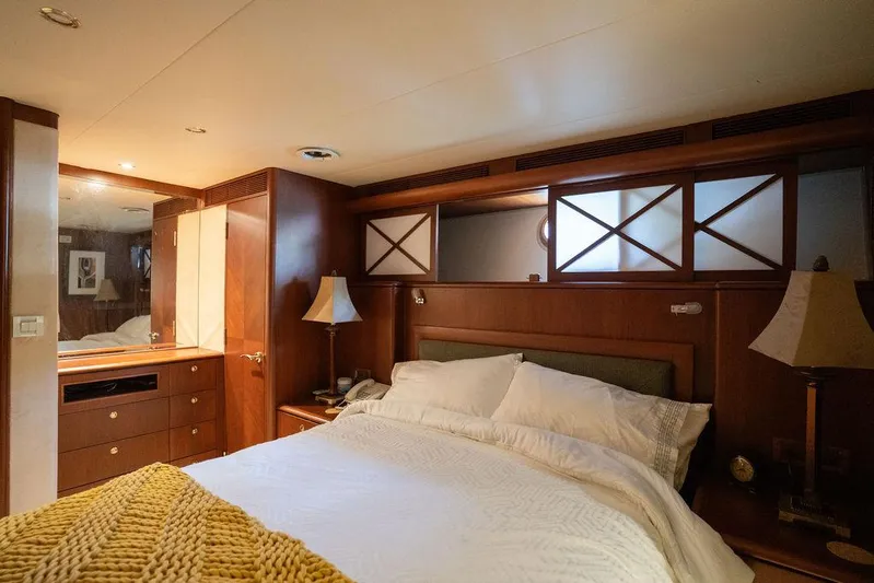  Yacht Photos Pics Luxurious bedroom interior of 2004 Cheoy Lee 84 Bravo Flybridge yacht with elegant wood finishes.