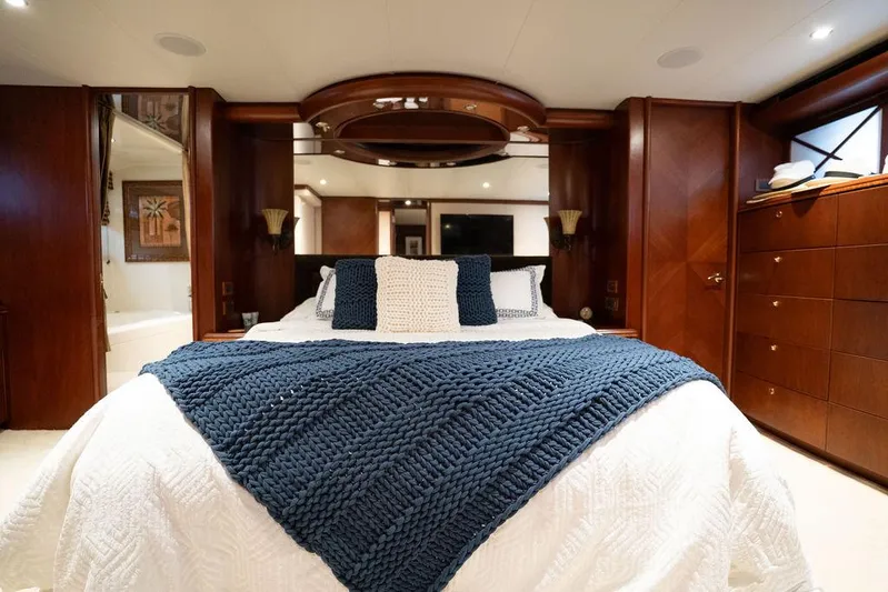  Yacht Photos Pics Luxurious bedroom in 2004 Cheoy Lee 84 Bravo Flybridge yacht with elegant wood paneling.