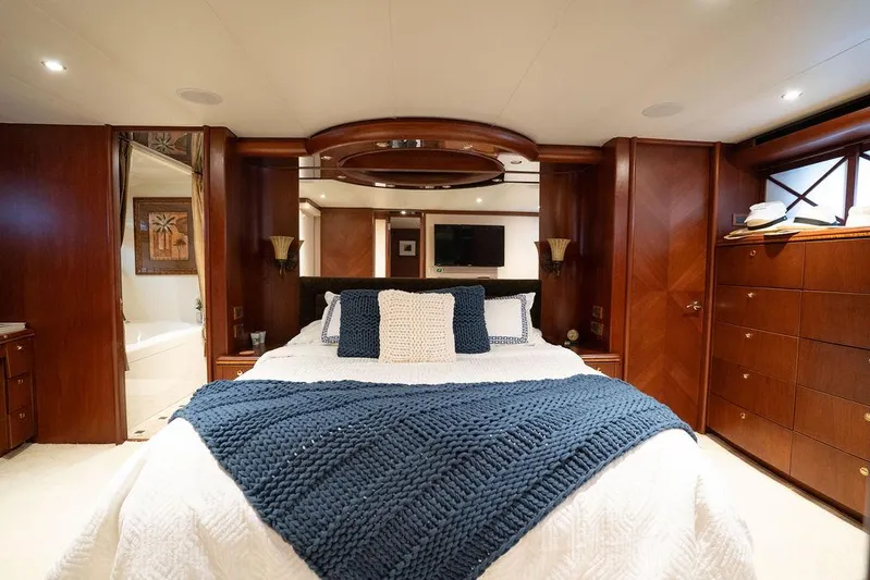  Yacht Photos Pics Luxurious bedroom in 2004 Cheoy Lee 84 Bravo Flybridge yacht with elegant wood finishes.