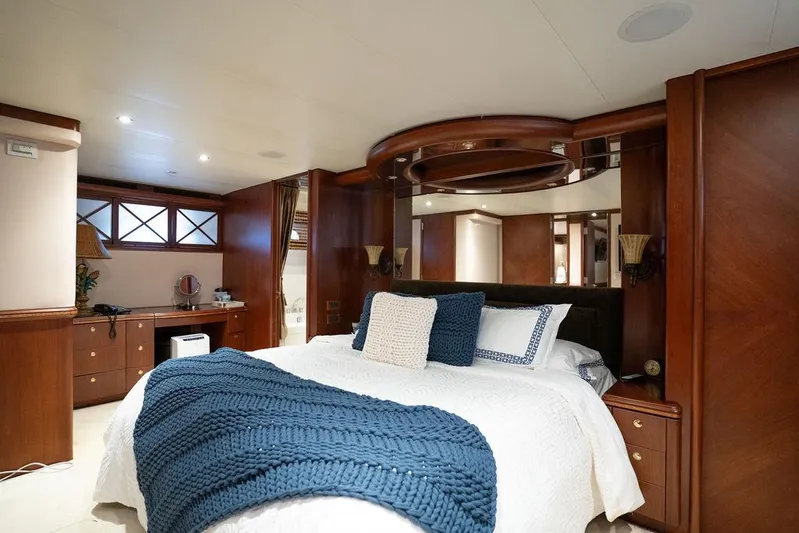  Yacht Photos Pics Luxurious bedroom interior of 2004 Cheoy Lee 84 Bravo Flybridge yacht with elegant wood finishes.