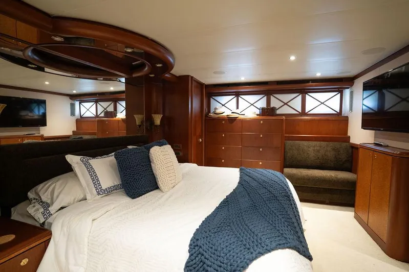  Yacht Photos Pics Luxurious bedroom in 2004 Cheoy Lee 84 Bravo Flybridge yacht with elegant wood finishes.