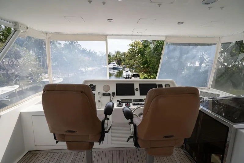  Yacht Photos Pics 2004 Cheoy Lee 84 Bravo Flybridge helm with dual seats and navigation equipment.