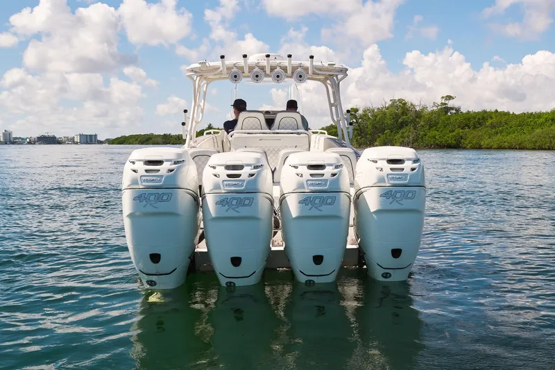  Yacht Photos Pics 2007 Midnight Express Cuddy boat with four powerful outboard engines on the water.